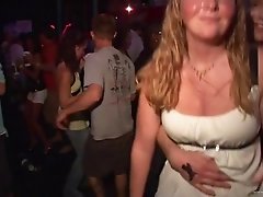 Sexy brunettes wearing shorts shake their butts in a club