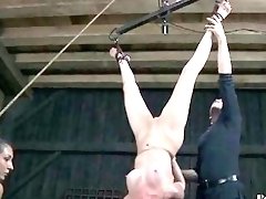 Tied up young woman endures hard punishment from BDSM master